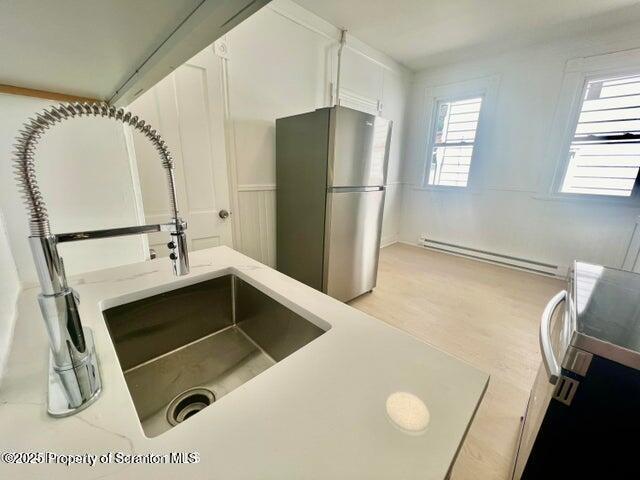 2036 Rigg Street, Unit A Dunmore, PA 18512 - Photo 3 of 8 a kitchen with a refrigerator and white cabinets