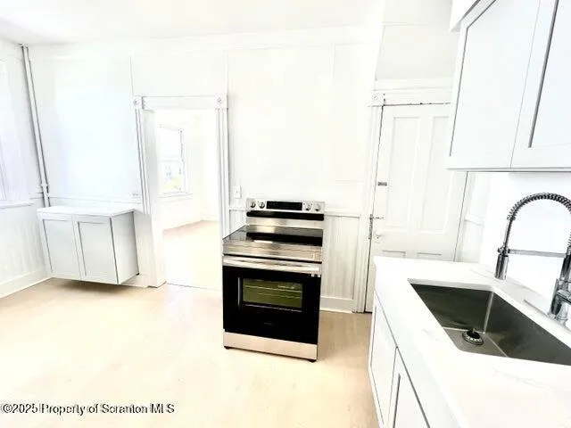 a kitchen with a sink a refrigerator and a stove