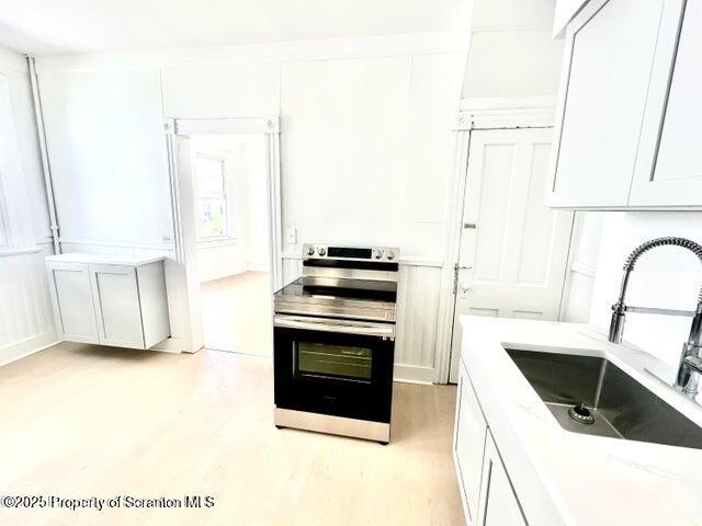 2036 Rigg Street, Unit A Dunmore, PA 18512 - Photo 7 of 8 a kitchen with a sink stove and cabinets