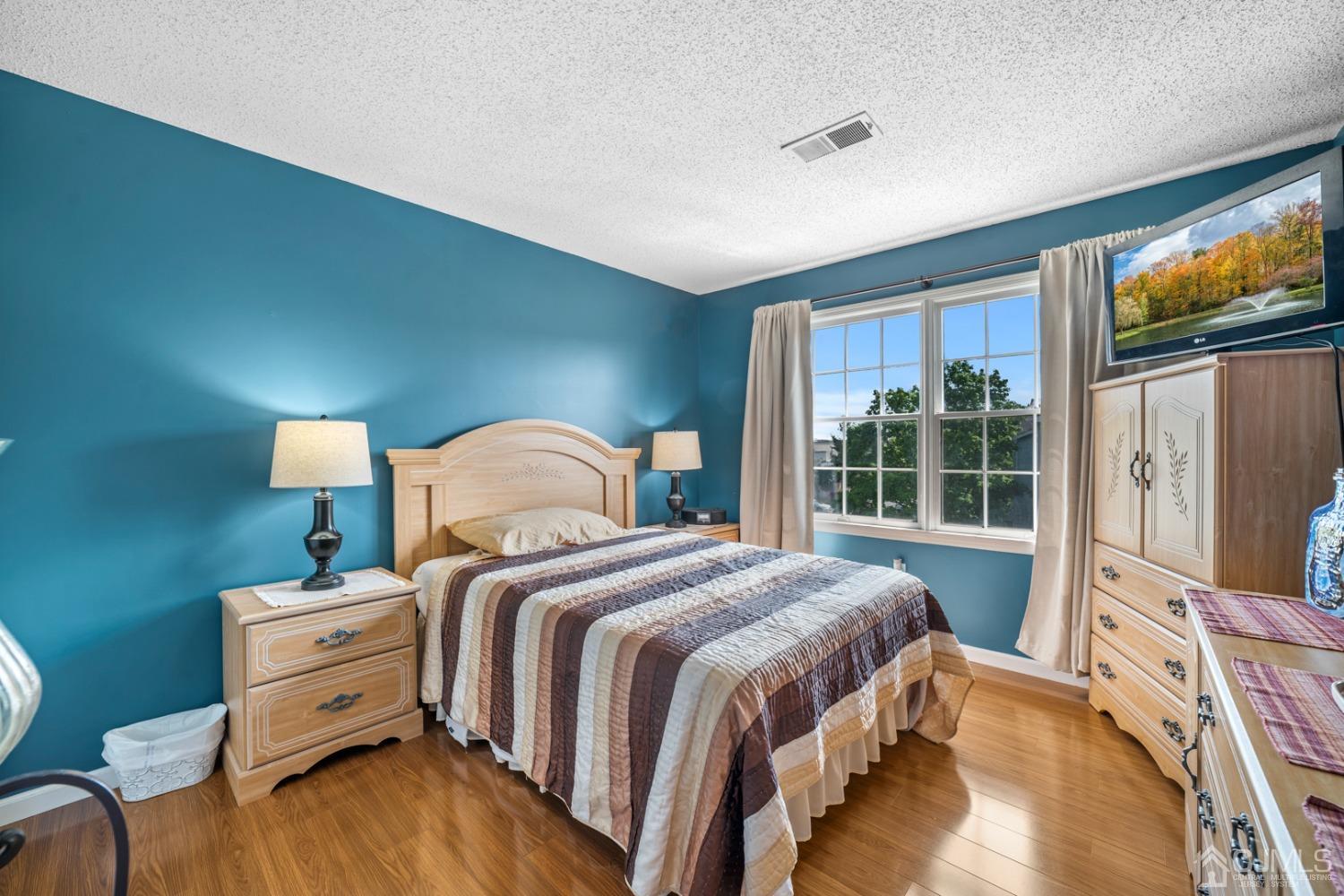 133 Edpas Road New Brunswick, NJ 08901 - Photo 12 of 17 a bedroom with a bed and a large window