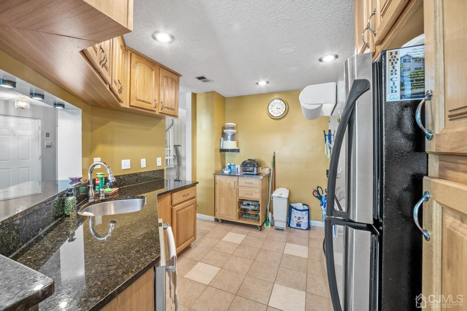 133 Edpas Road New Brunswick, NJ 08901 - Photo 8 of 17 a kitchen with stainless steel appliances granite countertop a refrigerator and a stove
