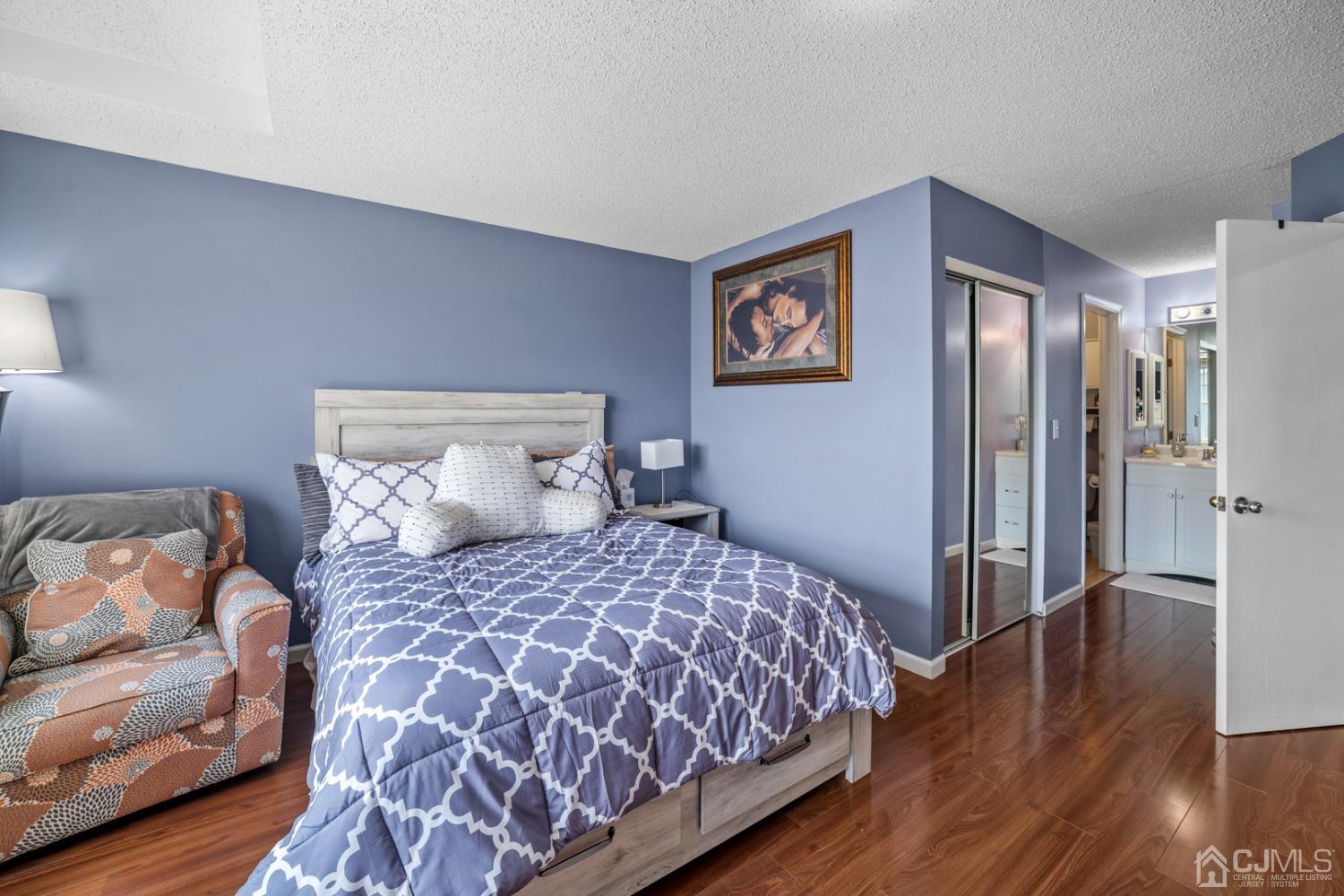 133 Edpas Road New Brunswick, NJ 08901 - Photo 9 of 17 a bedroom with a bed and wooden floor