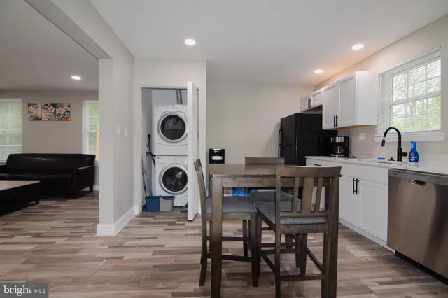 a kitchen with stainless steel appliances granite countertop a kitchen island hardwood floor sink and stove
