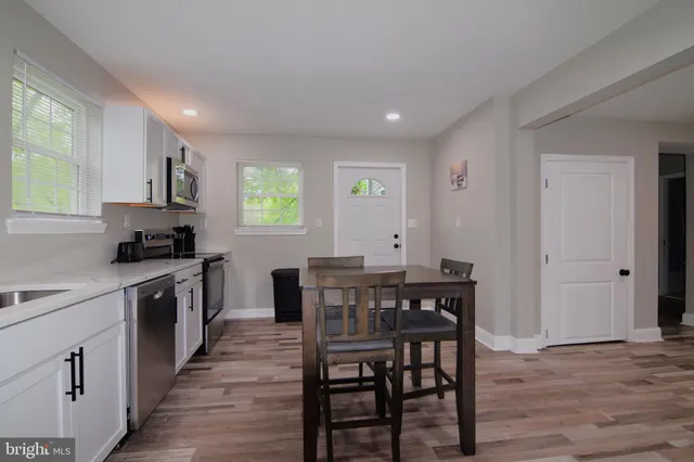 a bathroom with a granite countertop toilet sink and mirror