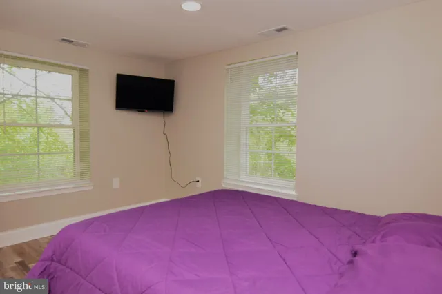 a bedroom with a bed and a mirror