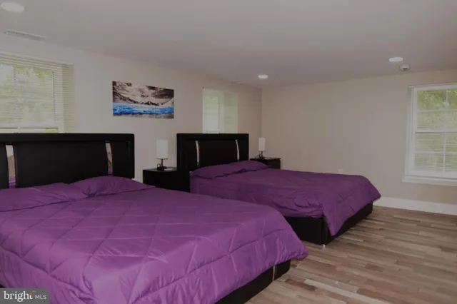 a bathroom with a sink a shower and a window