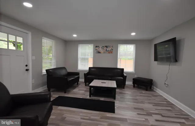 a kitchen with a table chairs sink and cabinets