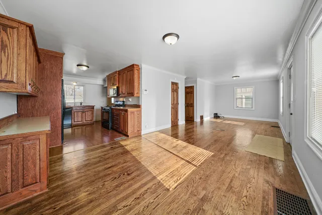 a large kitchen with cabinets and wooden floor