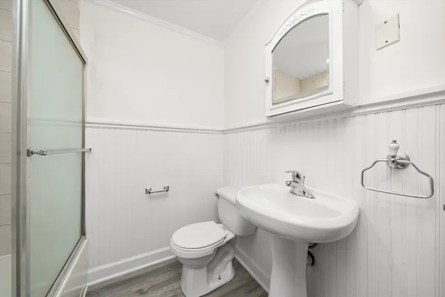 a bathroom with a sink a toilet and mirror