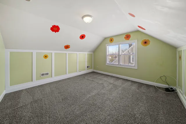 a view of a kitchen with wooden floor and white walls