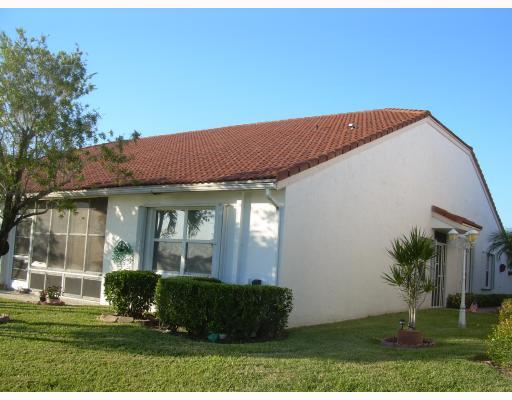 6096 Caladium Road Delray Beach, FL 33484 - Photo 3 of 12 a front view of a house with a yard
