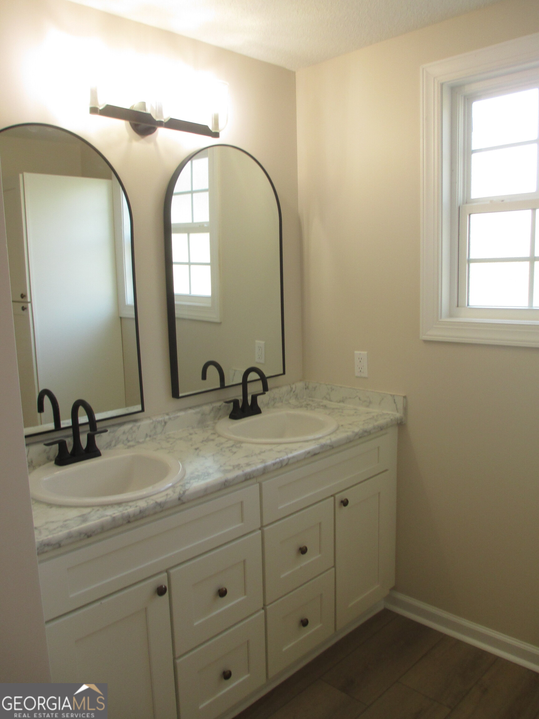 390 Bay Street Baxley, GA 31513 - Photo 24 of 24 a bathroom with a sink and a mirror