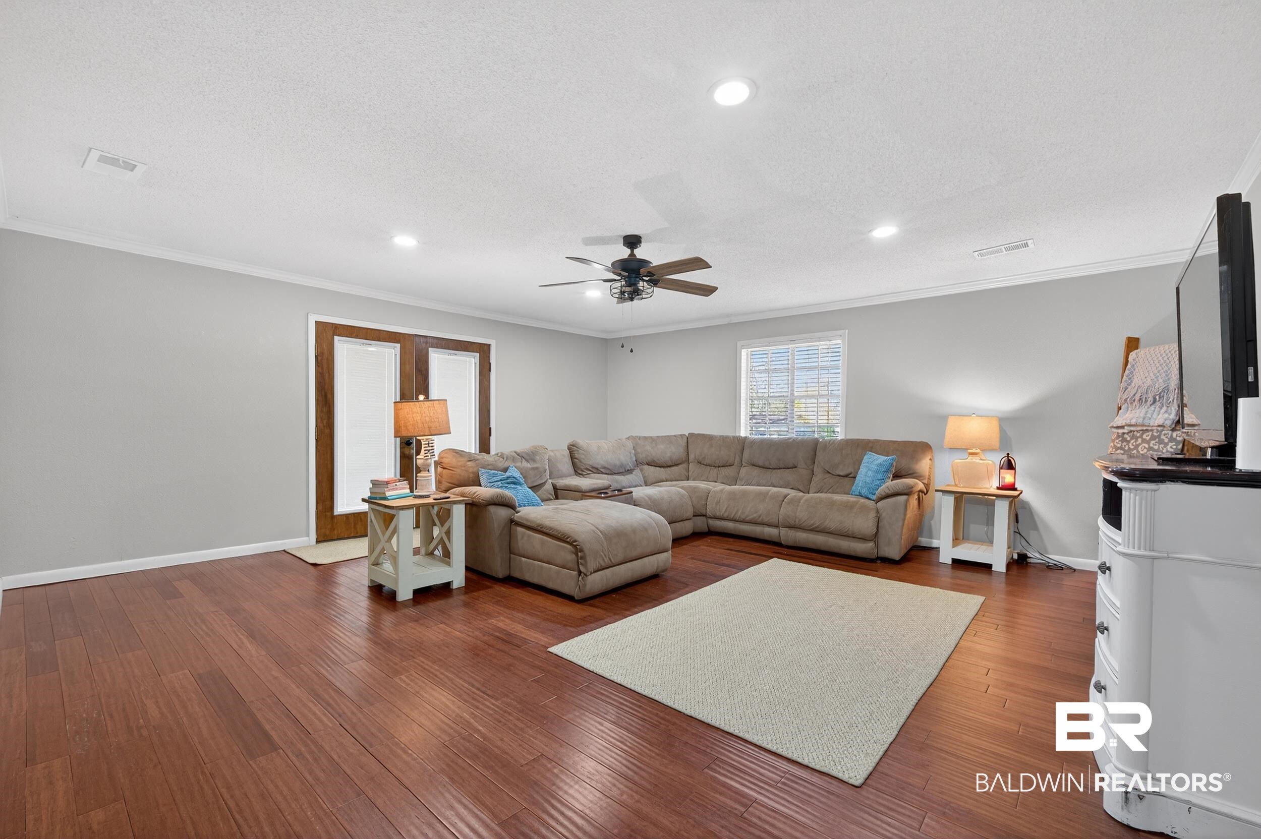 46006 Pecan Lane Bay Minette, AL 36507 - Photo 9 of 40 Living room featuring ornamental molding, a ceiling fan, wood-type flooring, recessed lighting, and a textured ceiling