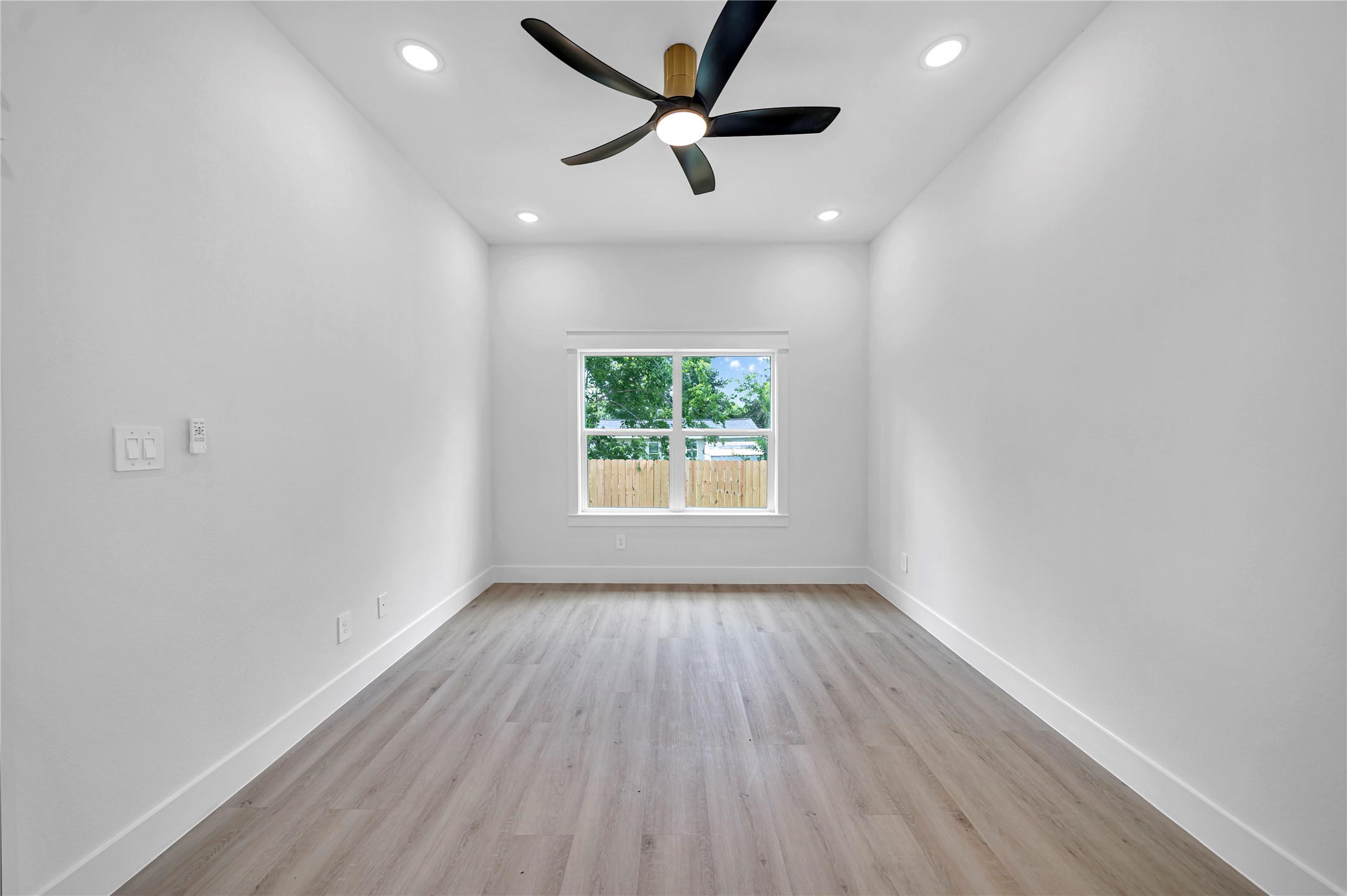 4834 Higgins Street, Unit B Houston, TX 77033 - Photo 13 of 34 wooden floor in an empty room with a window