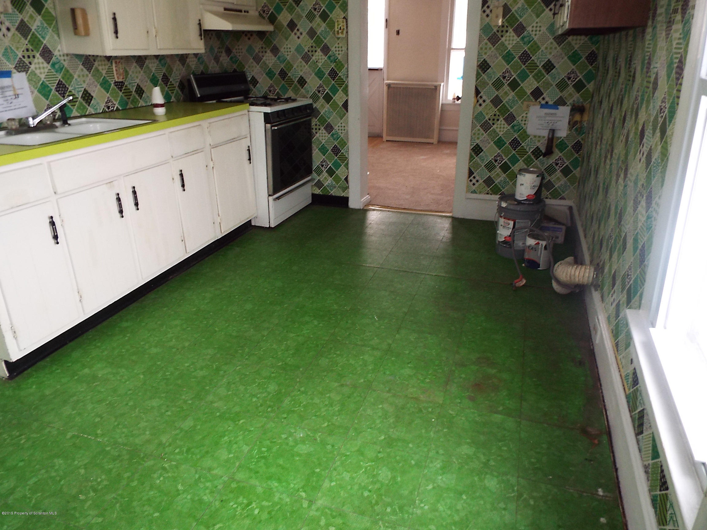 24 Rutz Street Ashley, PA 18706 - Photo 5 of 13 a kitchen with a fridge and a sink