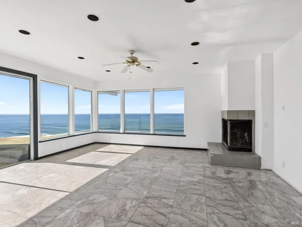a large bedroom with a bed and glass floor