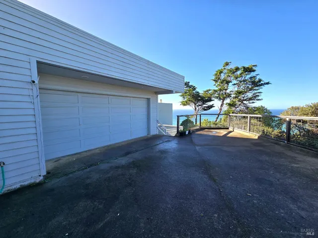 a living room with a couch and a dining table with wooden floor