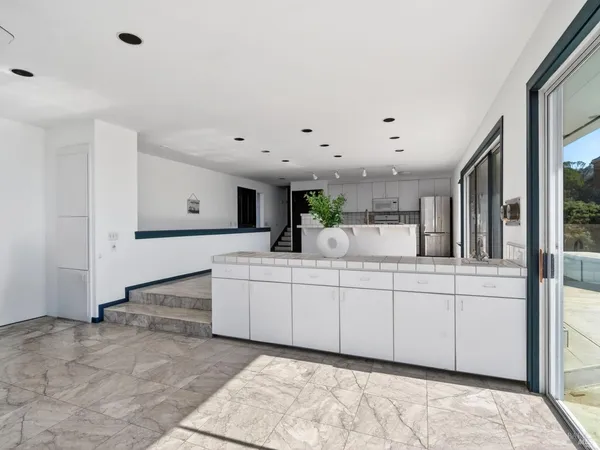 a kitchen with a sink and white cabinets