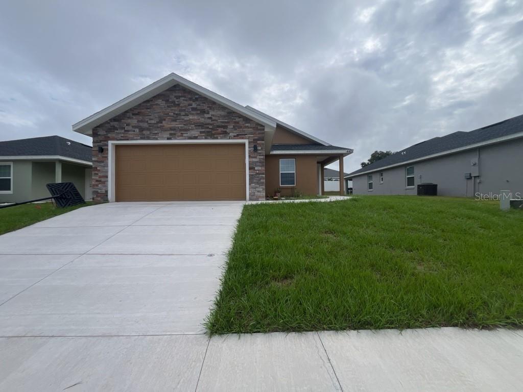 a front view of house with yard and green space