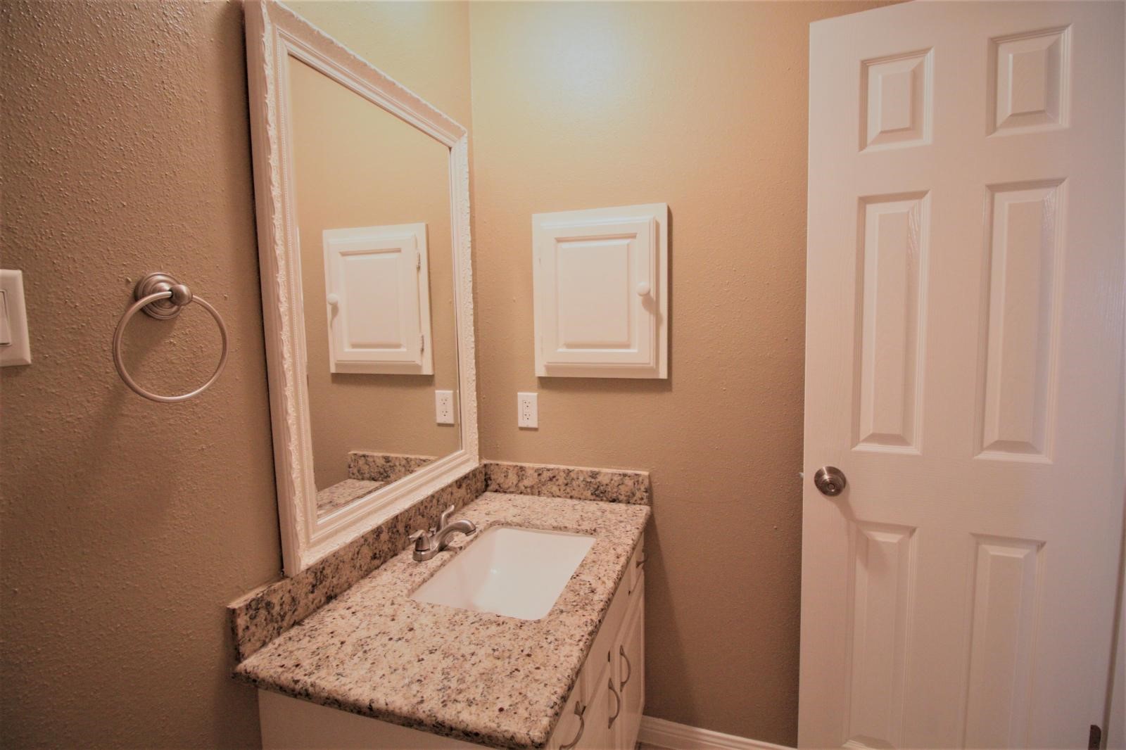 2618 Quarry Hill Road Sugar Land, TX 77478 - Photo 10 of 15 a bathroom with a granite countertop sink and a mirror