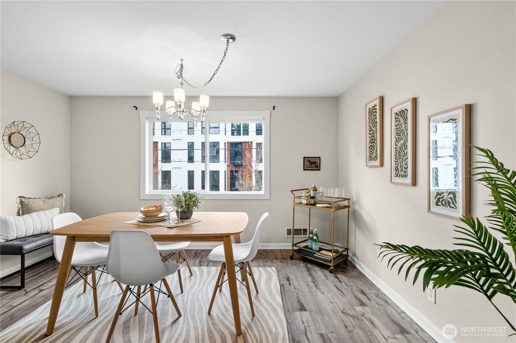 8720 Phinney Avenue North, Unit 11 Seattle, WA 98103 - Photo 13 of 28 a view of a dining room with furniture wooden floor and chandelier