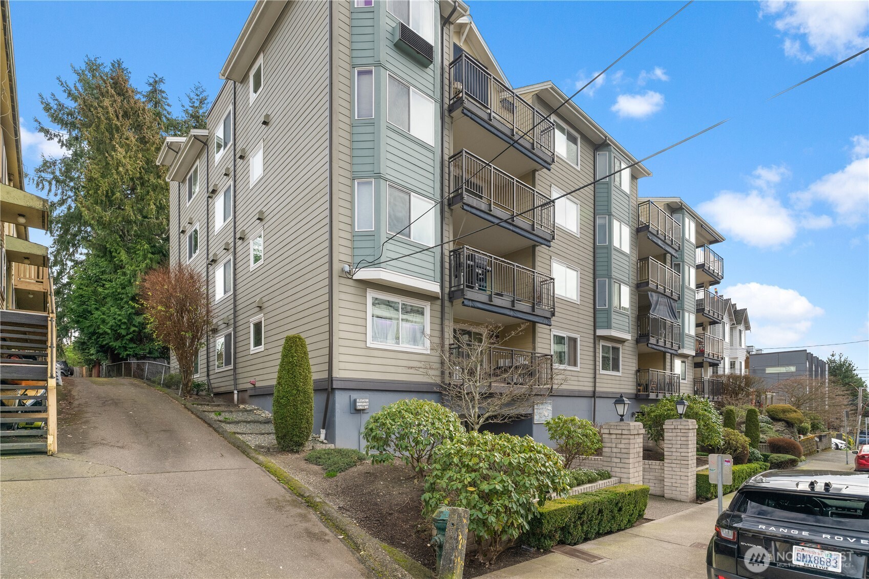 8720 Phinney Avenue North, Unit 11 Seattle, WA 98103 - Photo 26 of 28 a city street lined with buildings and cars