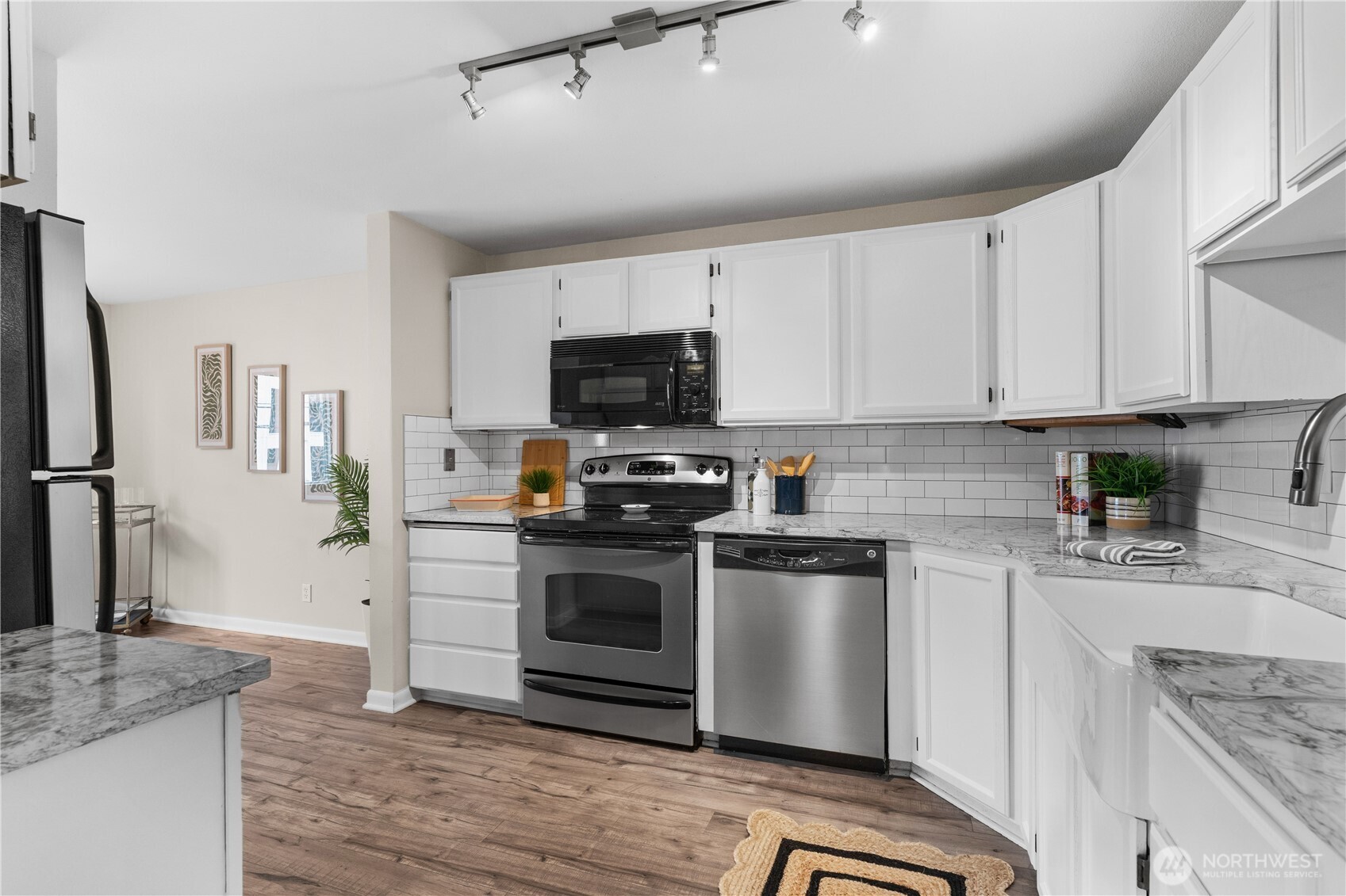 8720 Phinney Avenue North, Unit 11 Seattle, WA 98103 - Photo 9 of 28 a kitchen with granite countertop a sink and steel appliances