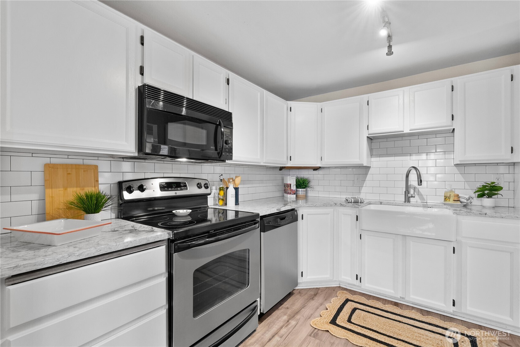 8720 Phinney Avenue North, Unit 11 Seattle, WA 98103 - Photo 10 of 28 a kitchen with cabinets stainless steel appliances and a counter space