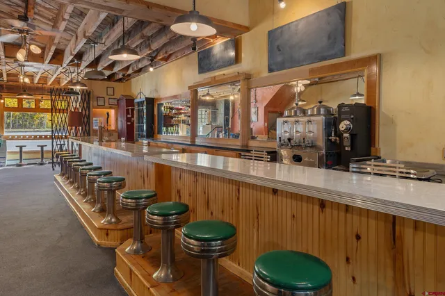 a kitchen with a stove a refrigerator and a sink
