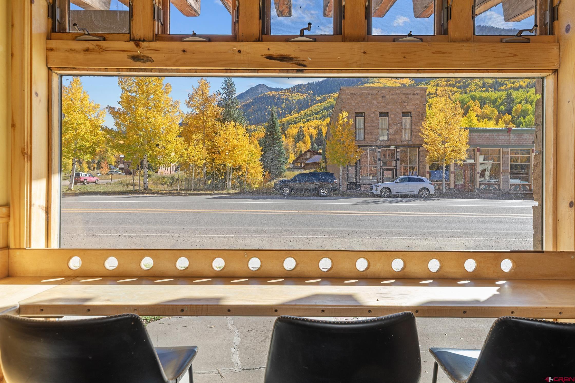 5 South Glasgow Avenue Rico, CO 81332 - Photo 8 of 21 a room with a table chairs and a painting on the wall