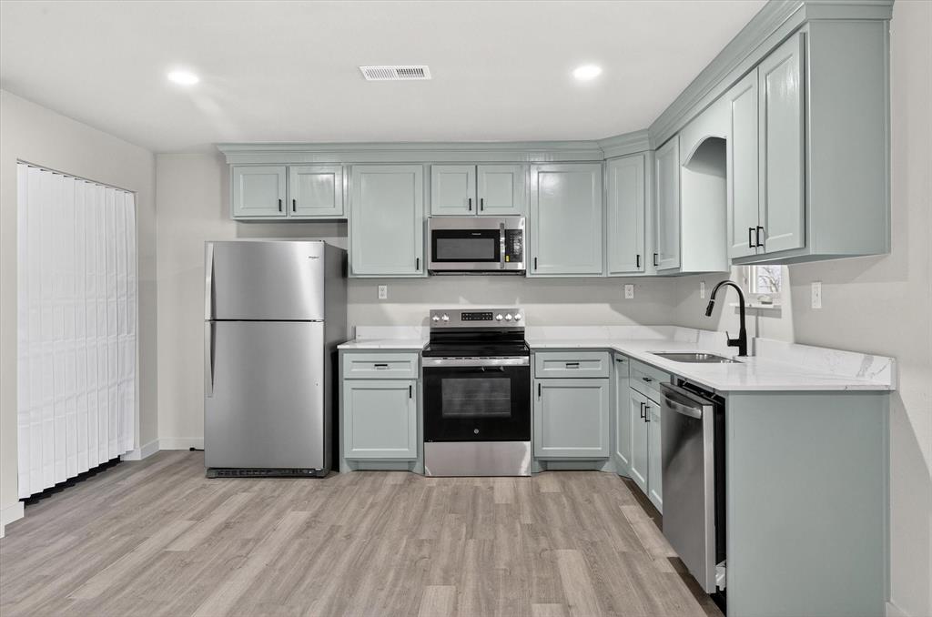 705 South 3rd Street East Dawson, TX 76639 - Photo 11 of 25 a kitchen with a refrigerator sink and white cabinets