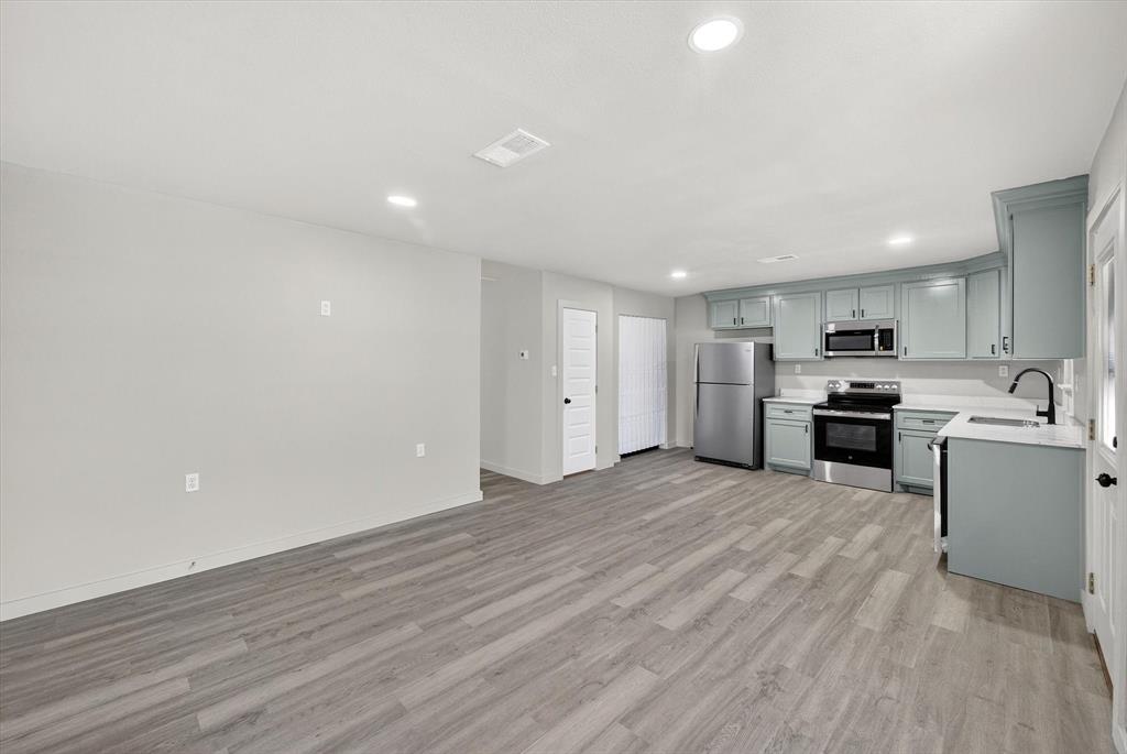 705 South 3rd Street East Dawson, TX 76639 - Photo 12 of 25 a view of kitchen with wooden floor and electronic appliances