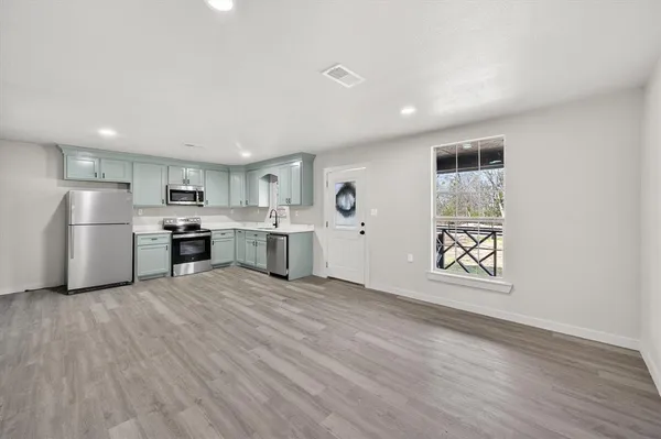 a view of kitchen with wooden floor and window