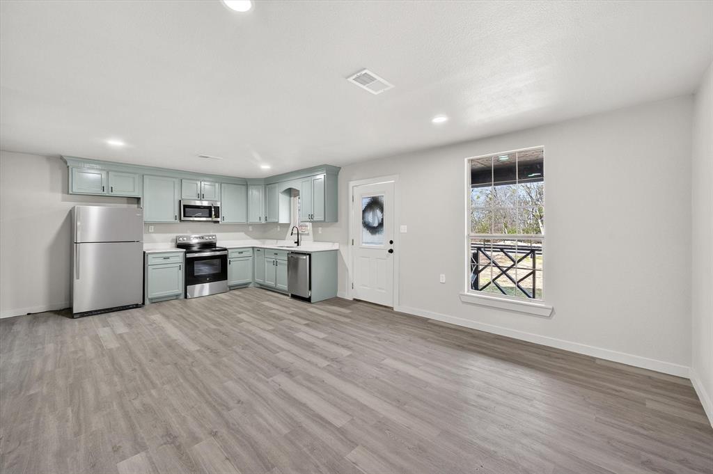 705 South 3rd Street East Dawson, TX 76639 - Photo 13 of 25 a view of kitchen with wooden floor and window