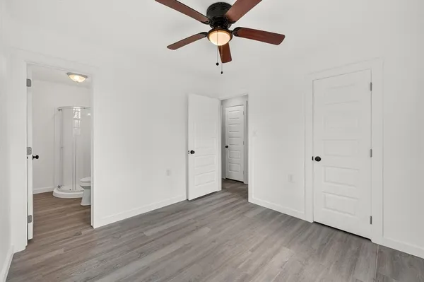 a view of an empty room and wooden floor