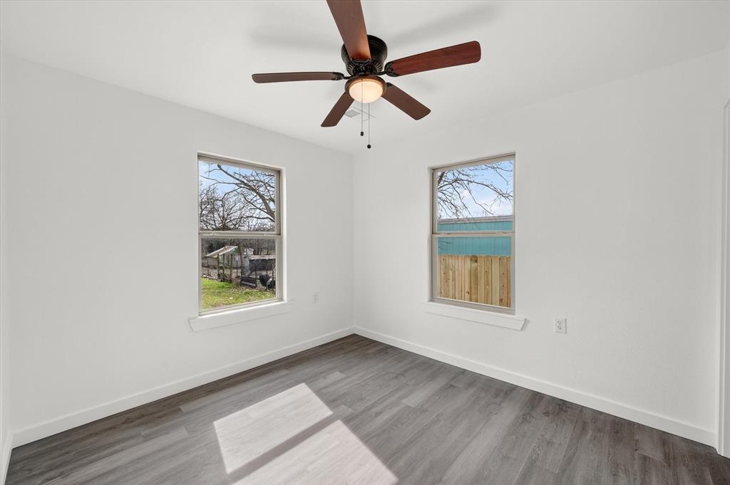 705 South 3rd Street East Dawson, TX 76639 - Photo 16 of 25 an empty room with windows and fan
