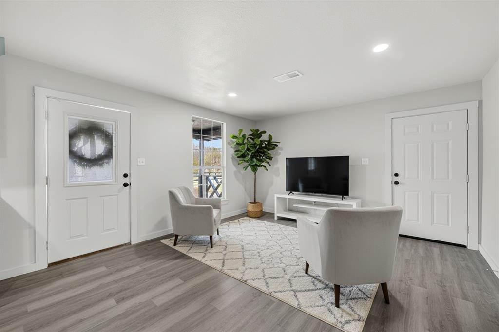 705 South 3rd Street East Dawson, TX 76639 - Photo 2 of 25 a living room with furniture and a flat screen tv