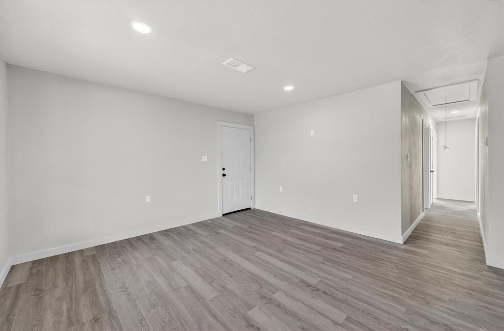 705 South 3rd Street East Dawson, TX 76639 - Photo 9 of 25 a view of an empty room with wooden floor