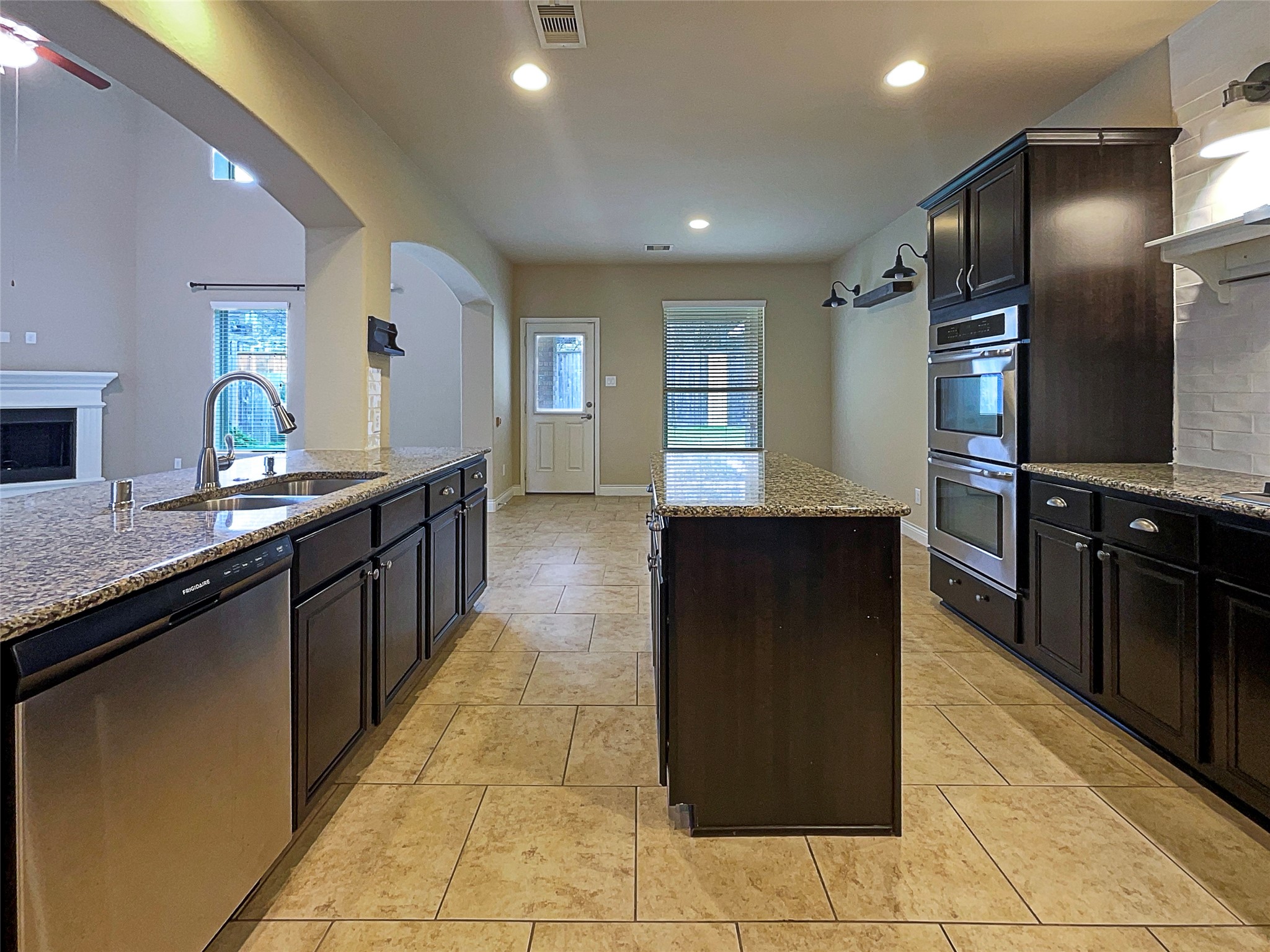 24542 North Denham Ridge Lane Spring, TX 77389 - Photo 13 of 26 a kitchen with stainless steel appliances granite countertop a refrigerator and a sink