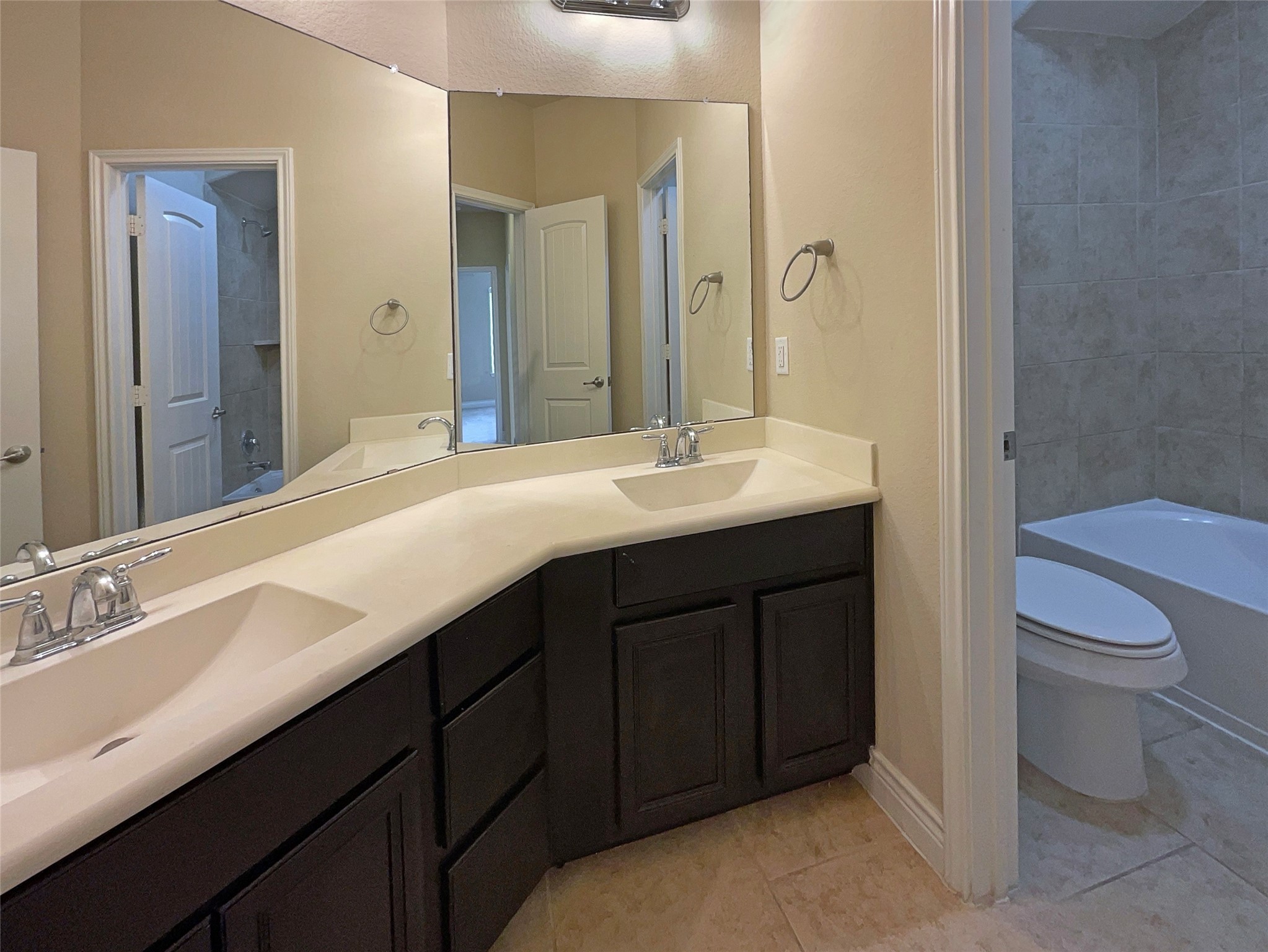 24542 North Denham Ridge Lane Spring, TX 77389 - Photo 23 of 26 a bathroom with a double vanity sink toilet and a mirror