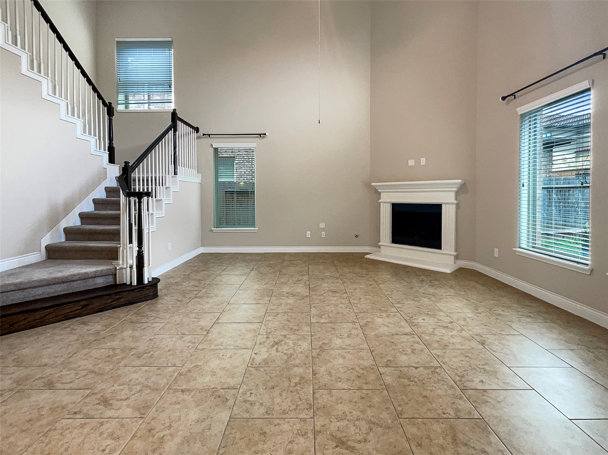 24542 North Denham Ridge Lane Spring, TX 77389 - Photo 3 of 26 a view of an empty room with wooden floor fireplace and a window