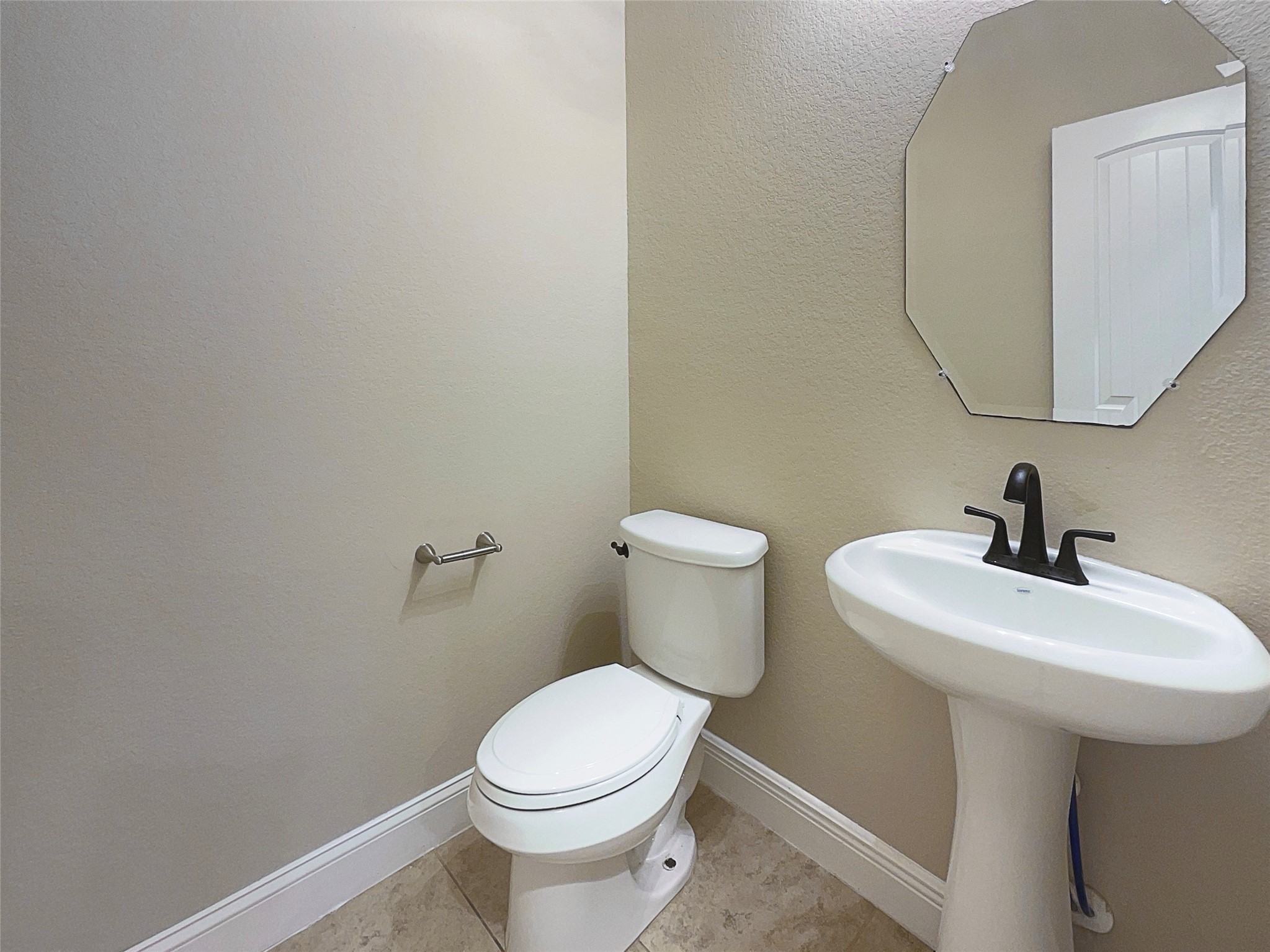 24542 North Denham Ridge Lane Spring, TX 77389 - Photo 8 of 26 a white toilet sitting next to a bathroom sink