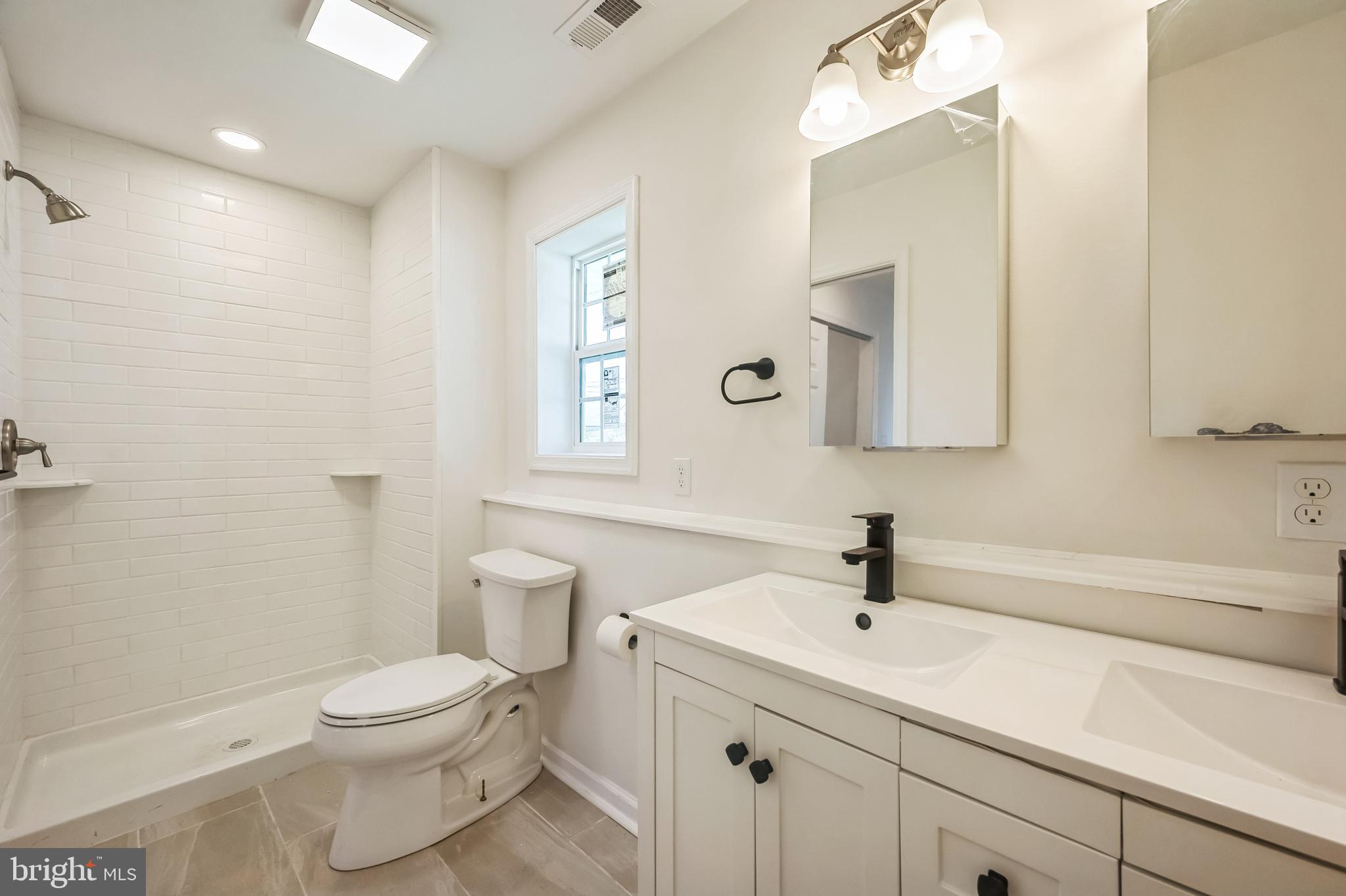 5 River Lane Levittown, PA 19055 - Photo 13 of 35 a bathroom with a sink a toilet and shower