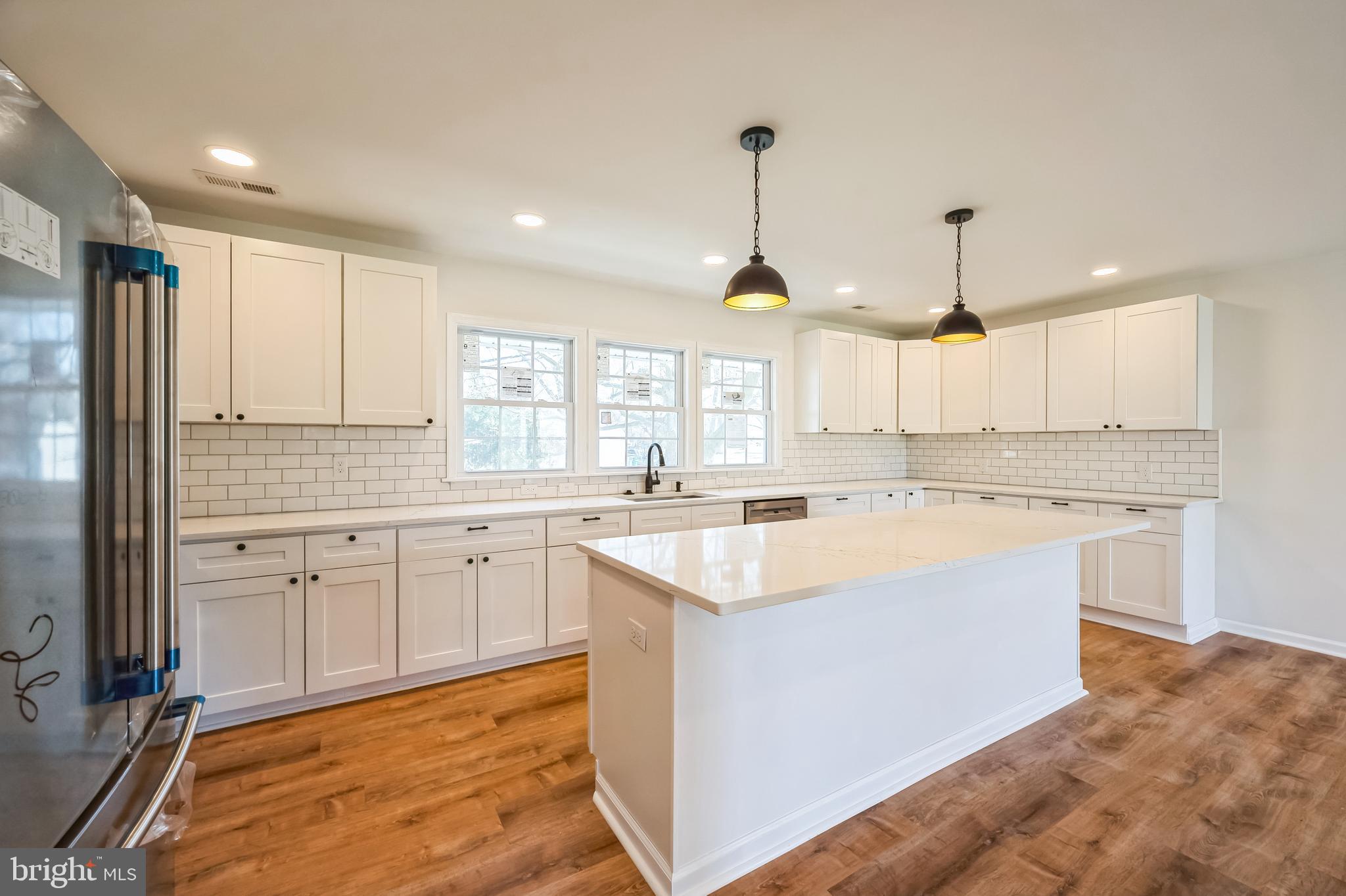 5 River Lane Levittown, PA 19055 - Photo 24 of 35 a large kitchen with kitchen island a sink stainless steel appliances and cabinets