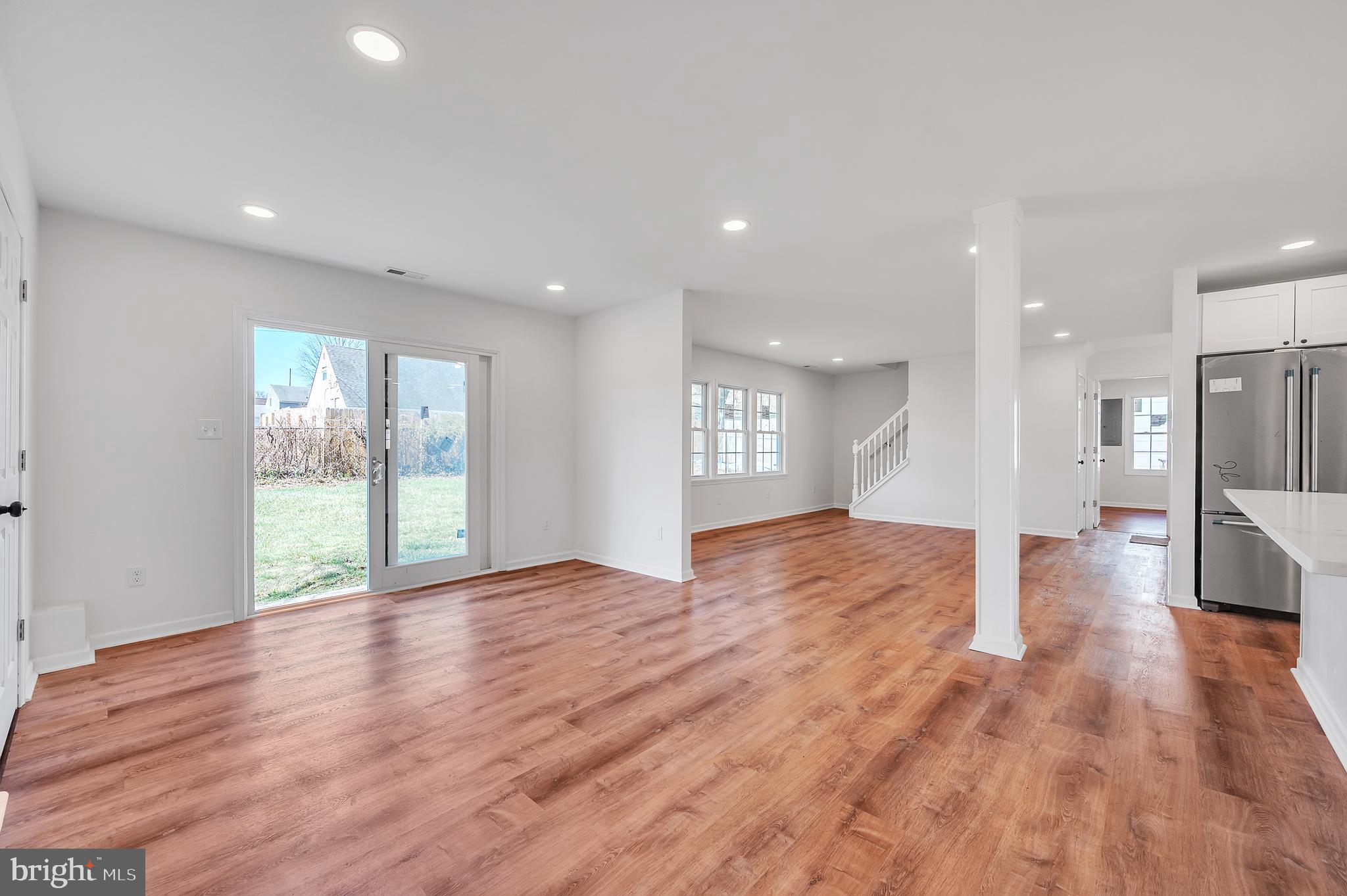 5 River Lane Levittown, PA 19055 - Photo 27 of 35 a view of an empty room with wooden floor and a kitchen