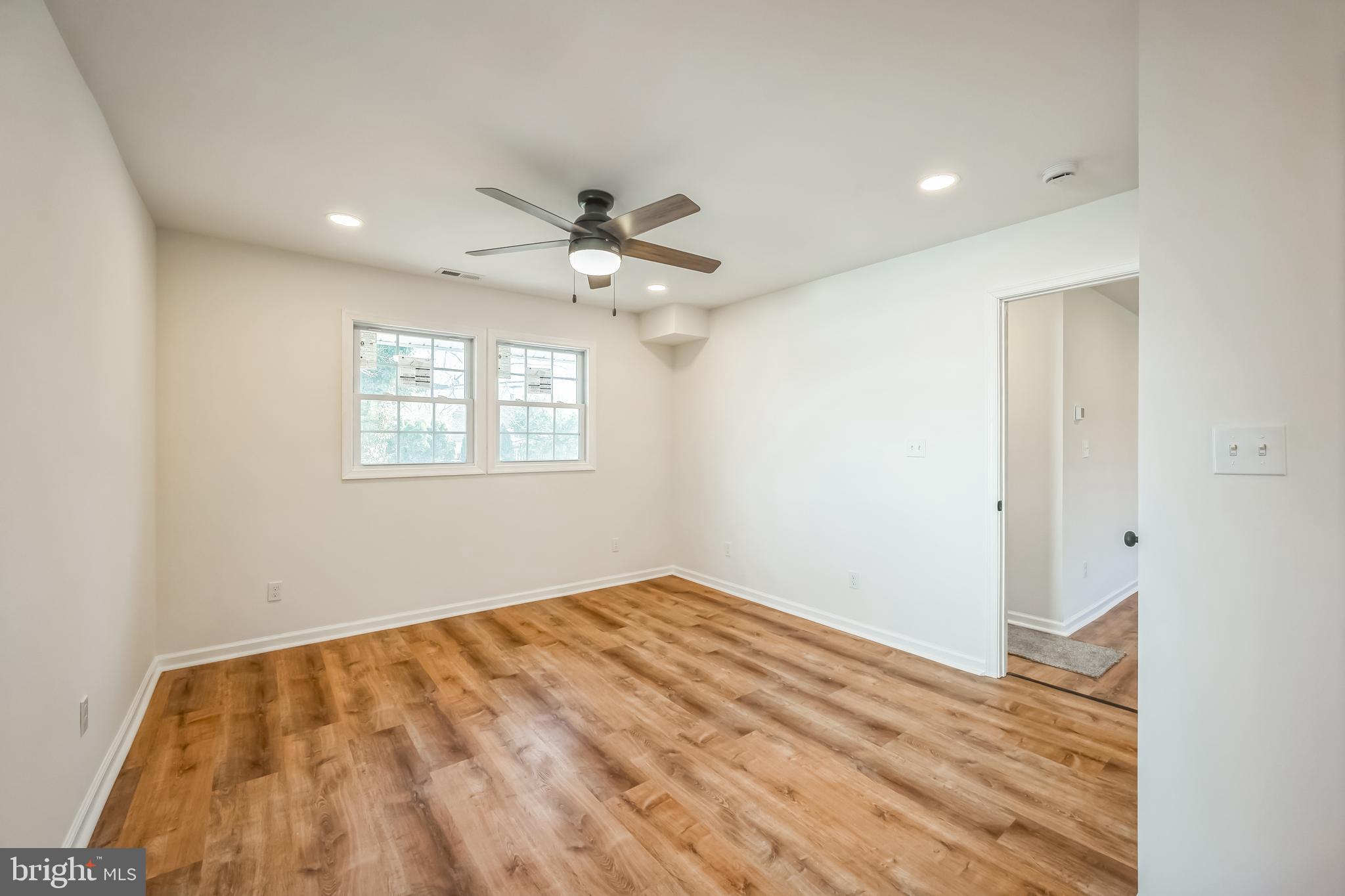 5 River Lane Levittown, PA 19055 - Photo 30 of 35 a view of a big room with wooden floor and chandelier fan
