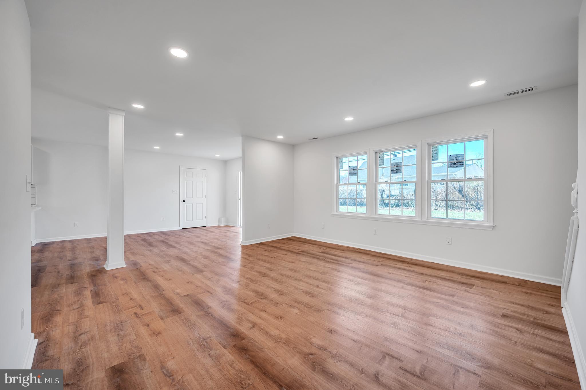 5 River Lane Levittown, PA 19055 - Photo 8 of 35 a view of an empty room with wooden floor and a window