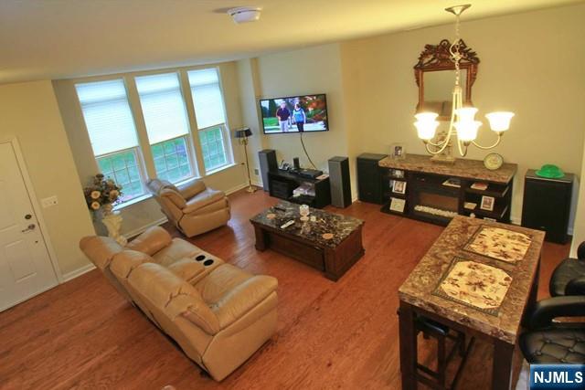 a living room with furniture and a chandelier