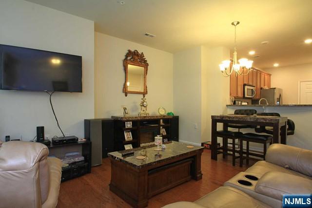 22 Clover Lane Garfield, NJ 07026 - Photo 2 of 17 a living room with furniture a flat screen tv and kitchen view