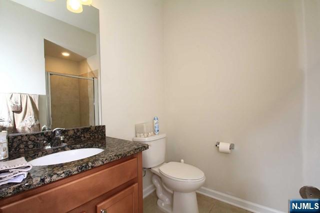 22 Clover Lane Garfield, NJ 07026 - Photo 7 of 17 a bathroom with a granite countertop sink and a mirror